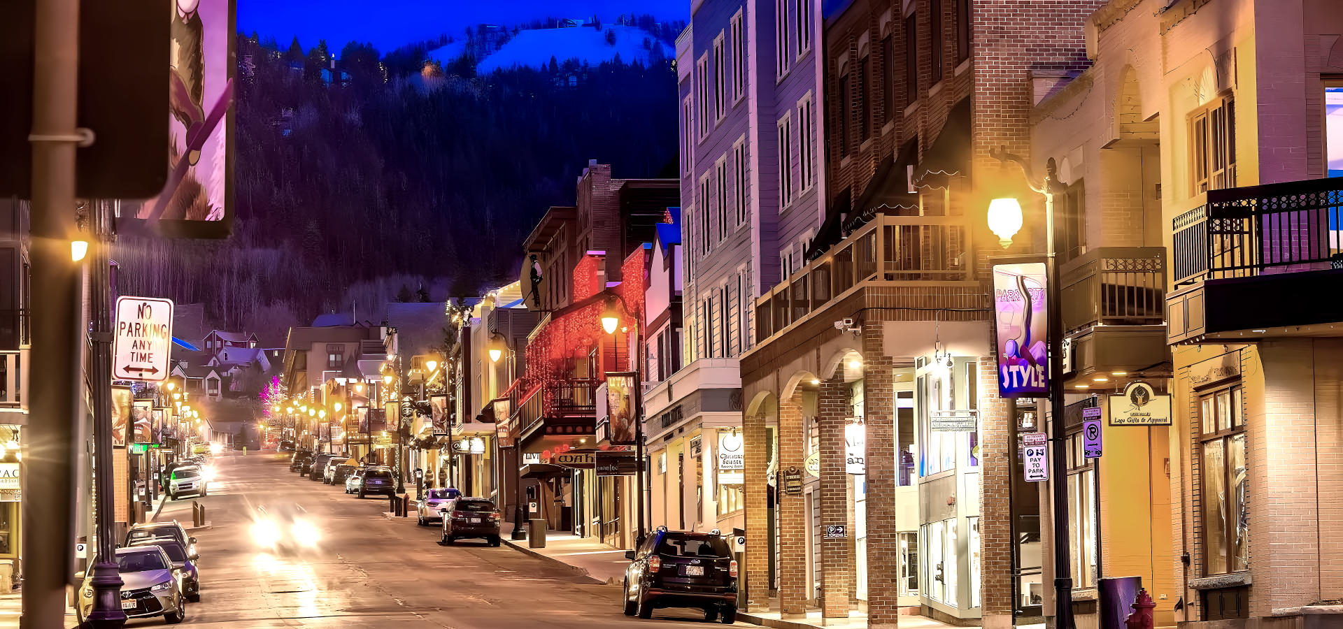 a city street with a lot of traffic with XE Park City's luxury transportation.